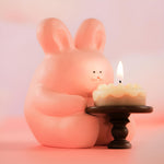 Cute bunny resin candle holder displayed in a cozy home setting with soft candlelight