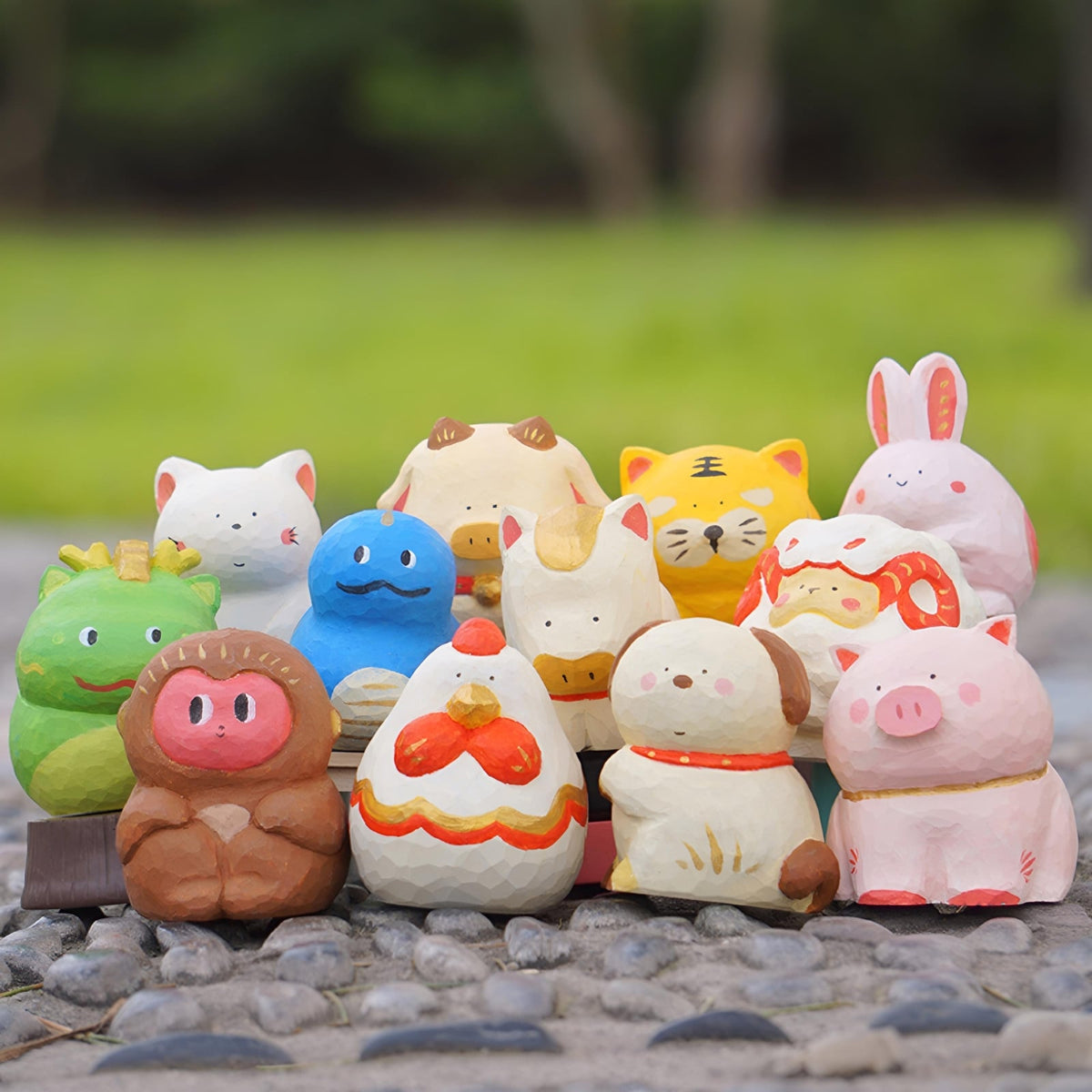 Outdoor display of Lunar Zodiac Series Figures by BigGallery showing twelve collectible zodiac animal figures in a playful art toy style