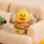 NINIGOGO Happy Day duck character mini figure displayed on cozy sofa setting as decorative collectible toy